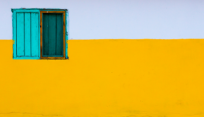 Photograph of a window on a yellow and white wall