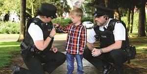 image of police officers talking to child