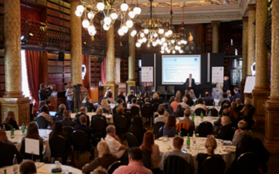 Image shows the launch event for CVSL at One Whitehall Place, London. The room is spectacular, with bright lights and opulent interior design. The room is filled with guests.