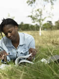 Girl reading in field