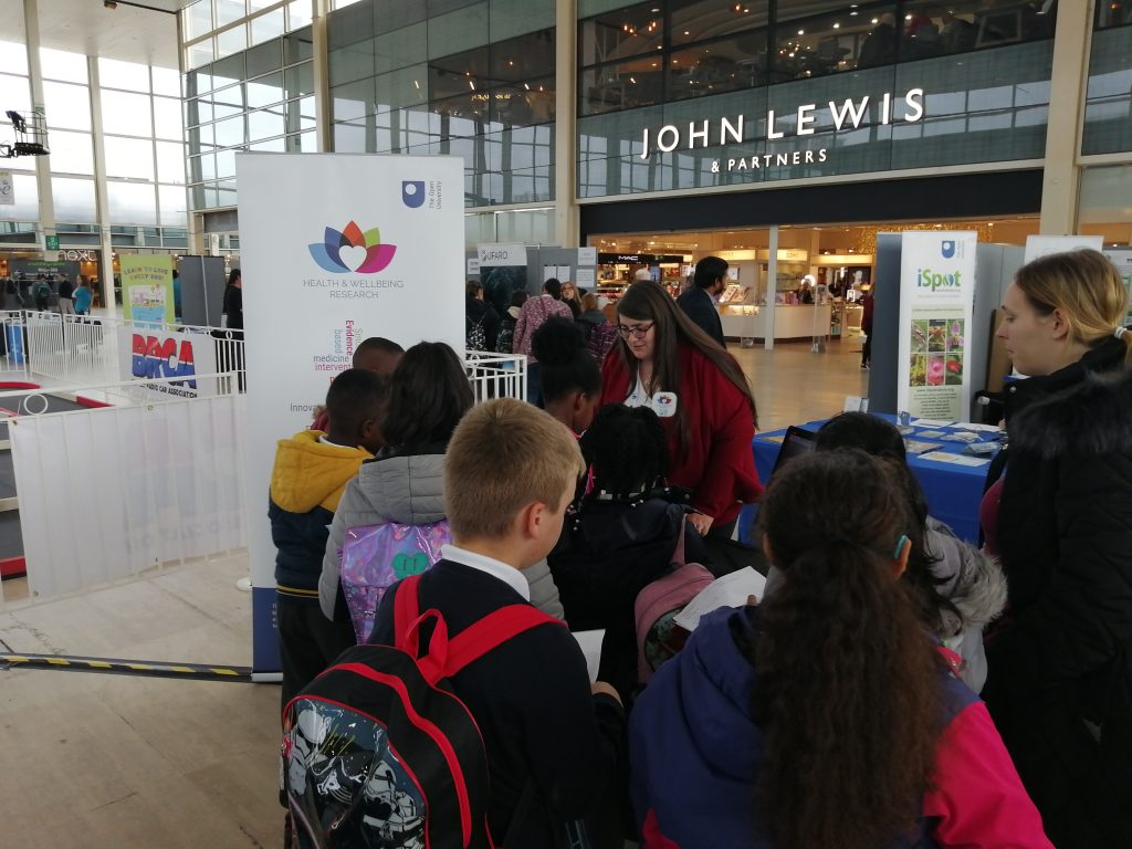 Children gathering at the Health and Wellbeing exhibition table