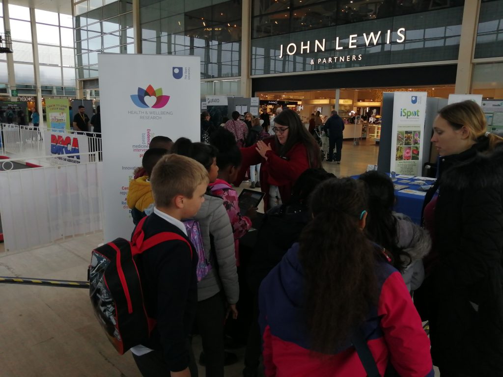 Children gathering at the Health and Wellbeing exhibition table