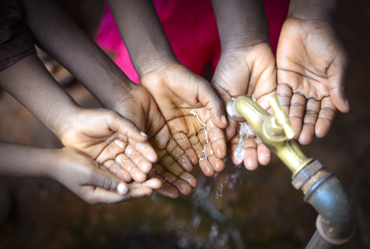 Photo of children's hands at water tap