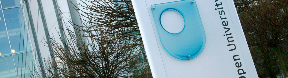 Open University sign outside a building on Walton Hall Campus