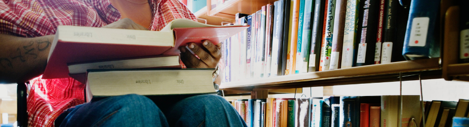 Student in a wheelchair browsing books in the library