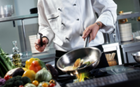 A photo of a chef in a kitchen mixing vegetables in a frying pan