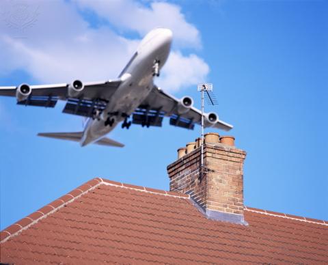 Plane flying low over houses