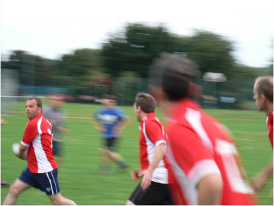 Blurry action shot of a pass whilst running
