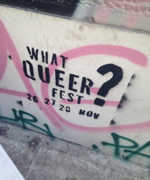 Concrete with graffiti that also states 'What Queer Fest? 26, 27, 20 Nov