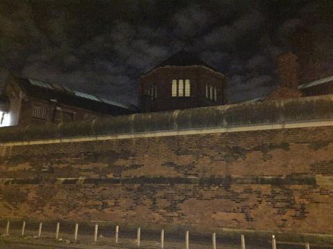 A prison building at night.