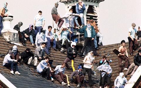  Prisoners on the roof at Strangeways Prison in 1990. Photo Credit: Rex https://www.telegraph.co.uk/news/uknews/law-and-order/11489148/Prison-conditions-as-bad-as-Strangeways-25-years-ago-Lord-Woolf-says.html