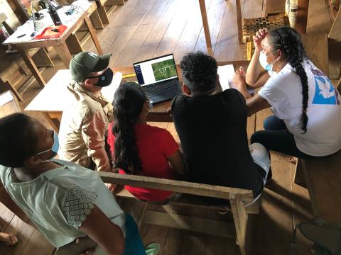Communities in Guyana working together on a laptop