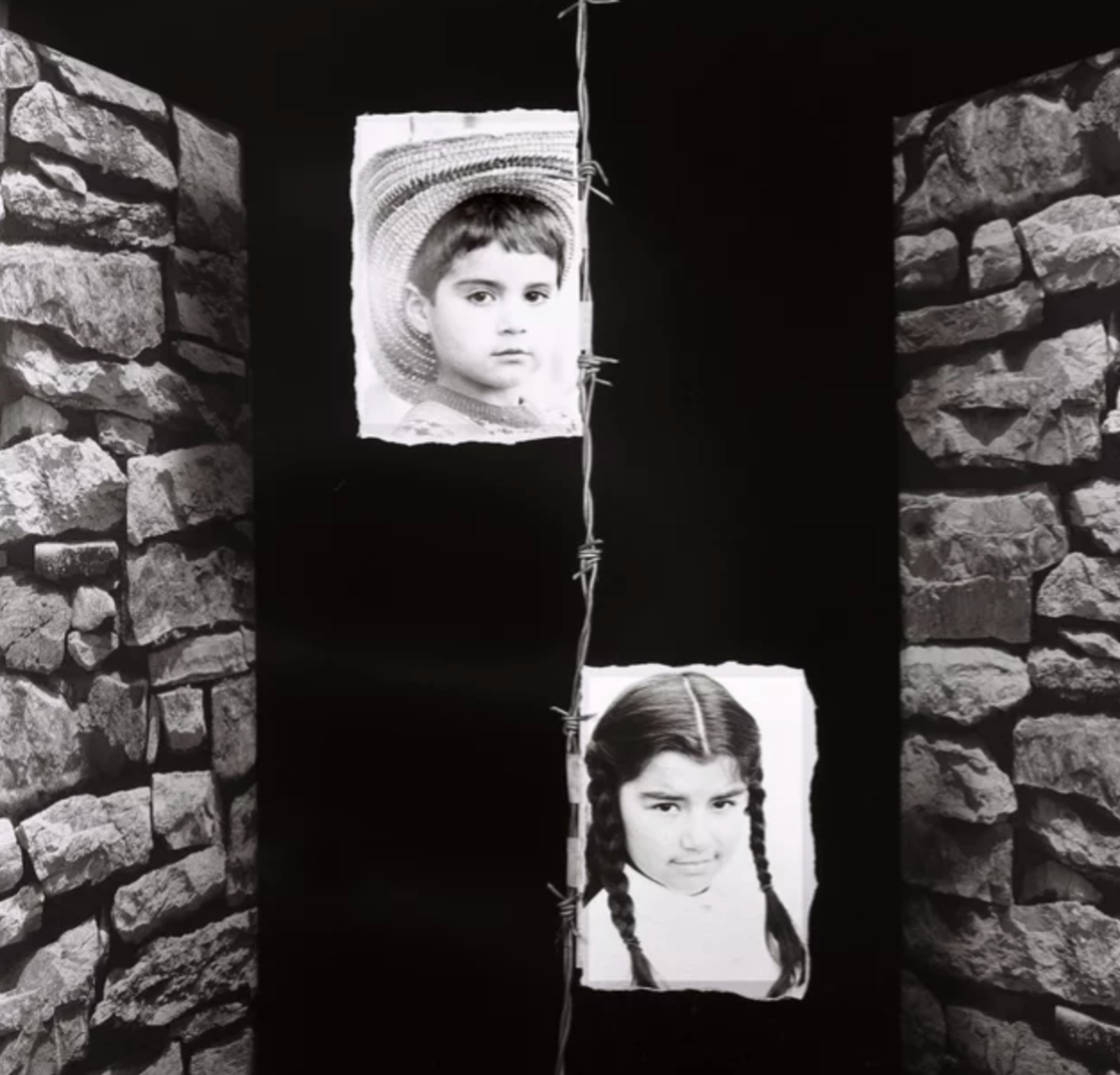 Black and white picture with a boy and girl ripped images stuck to a barbed wire