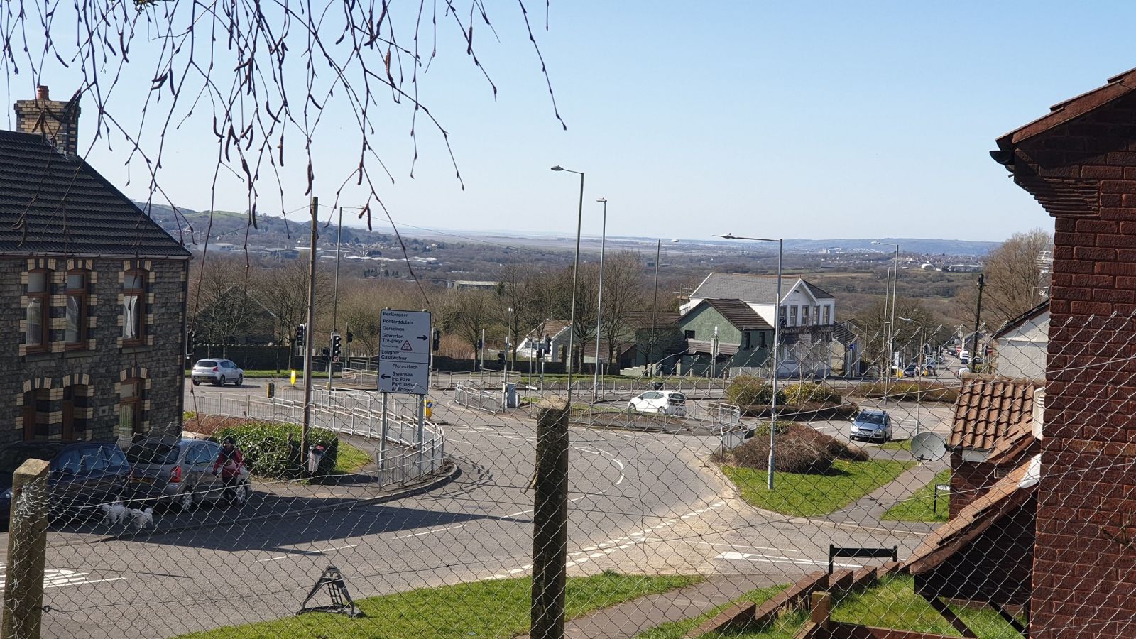 The town stretches into the distance beyond the fence the photographer stands behind