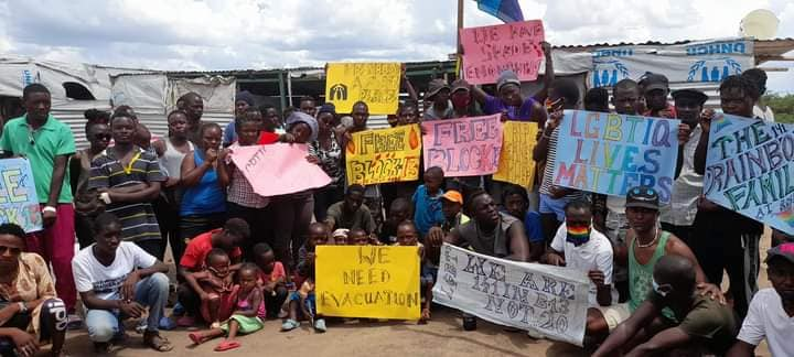 Regugees holding support placards