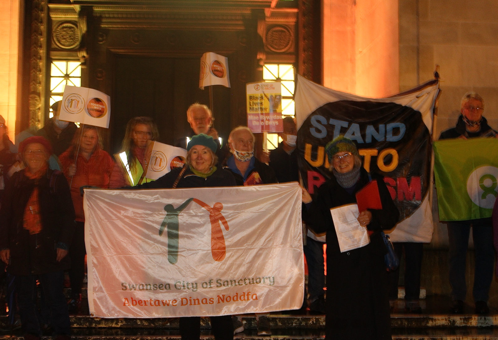 members of the community march at Guildhall with refugees