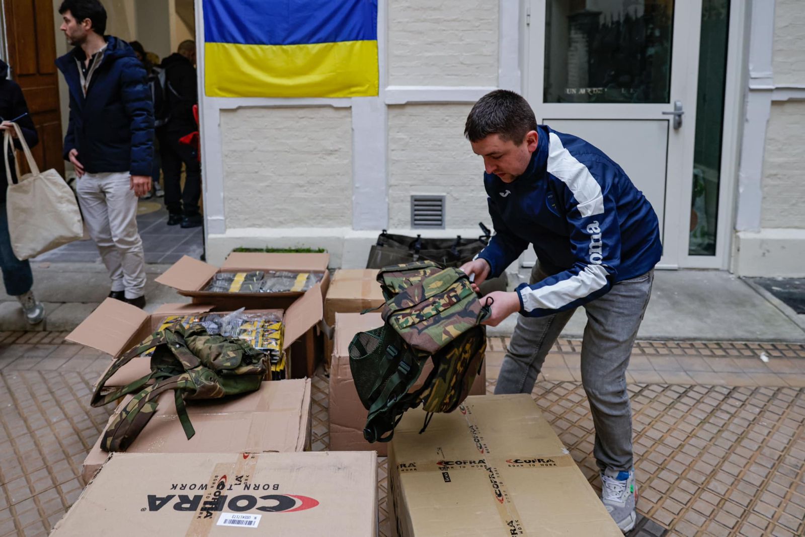 Volunteers organise goods as part of an initiative of football team FC Hoverla Paris