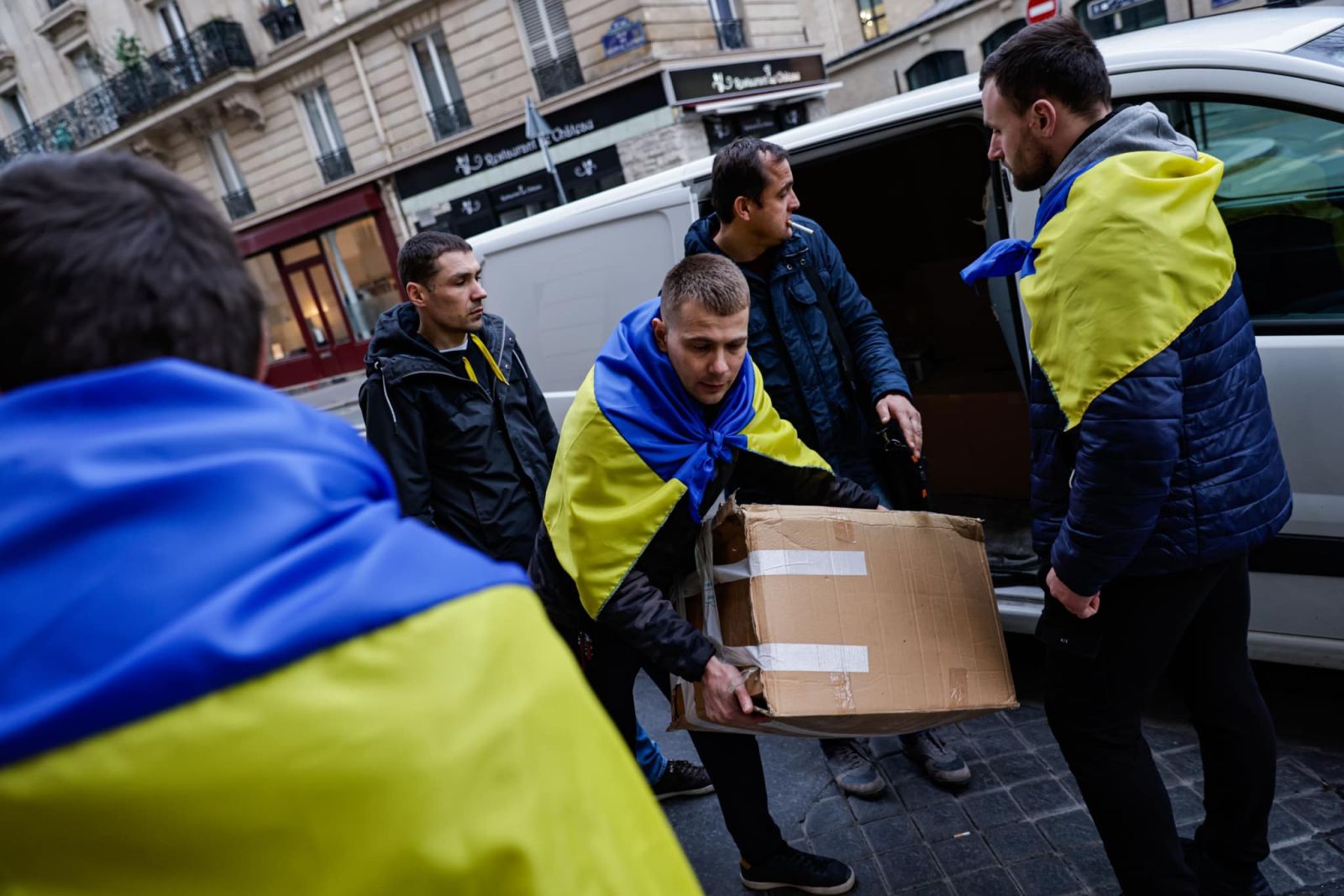 Volunteers organise goods as part of an initiative of football team FC Hoverla Paris