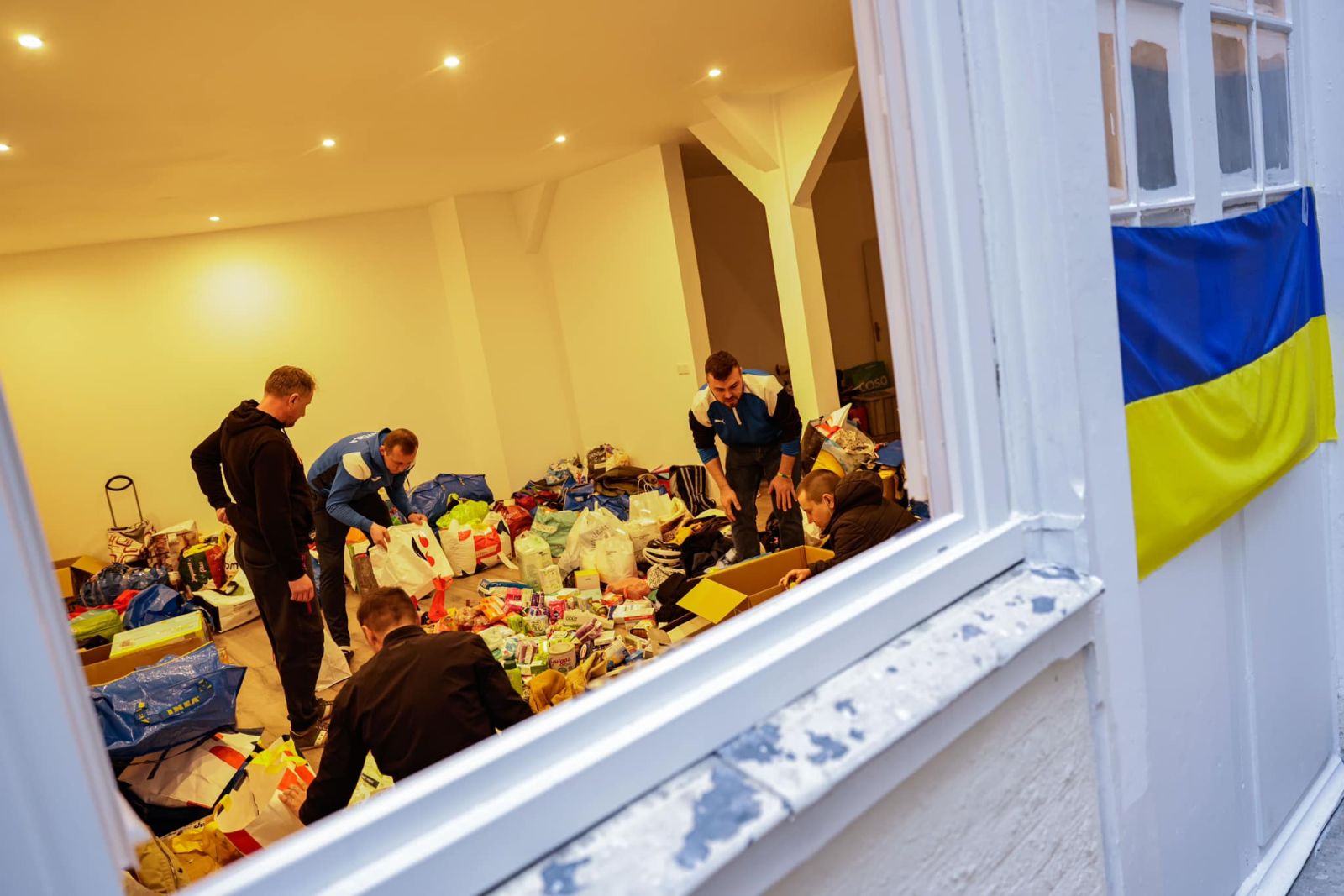 Volunteers organise goods as part of an initiative of football team FC Hoverla Paris