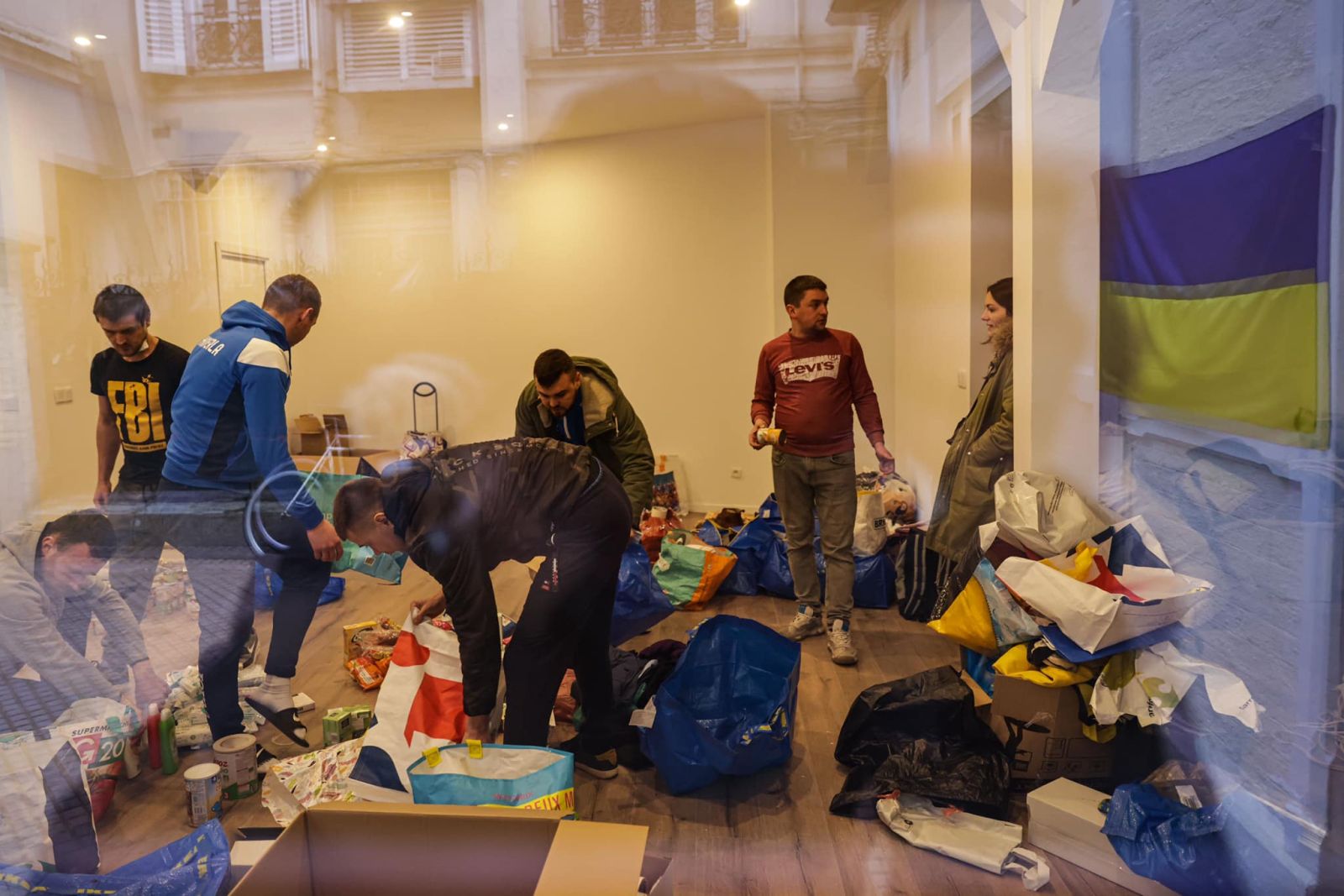 Volunteers organise goods as part of an initiative of football team FC Hoverla Paris