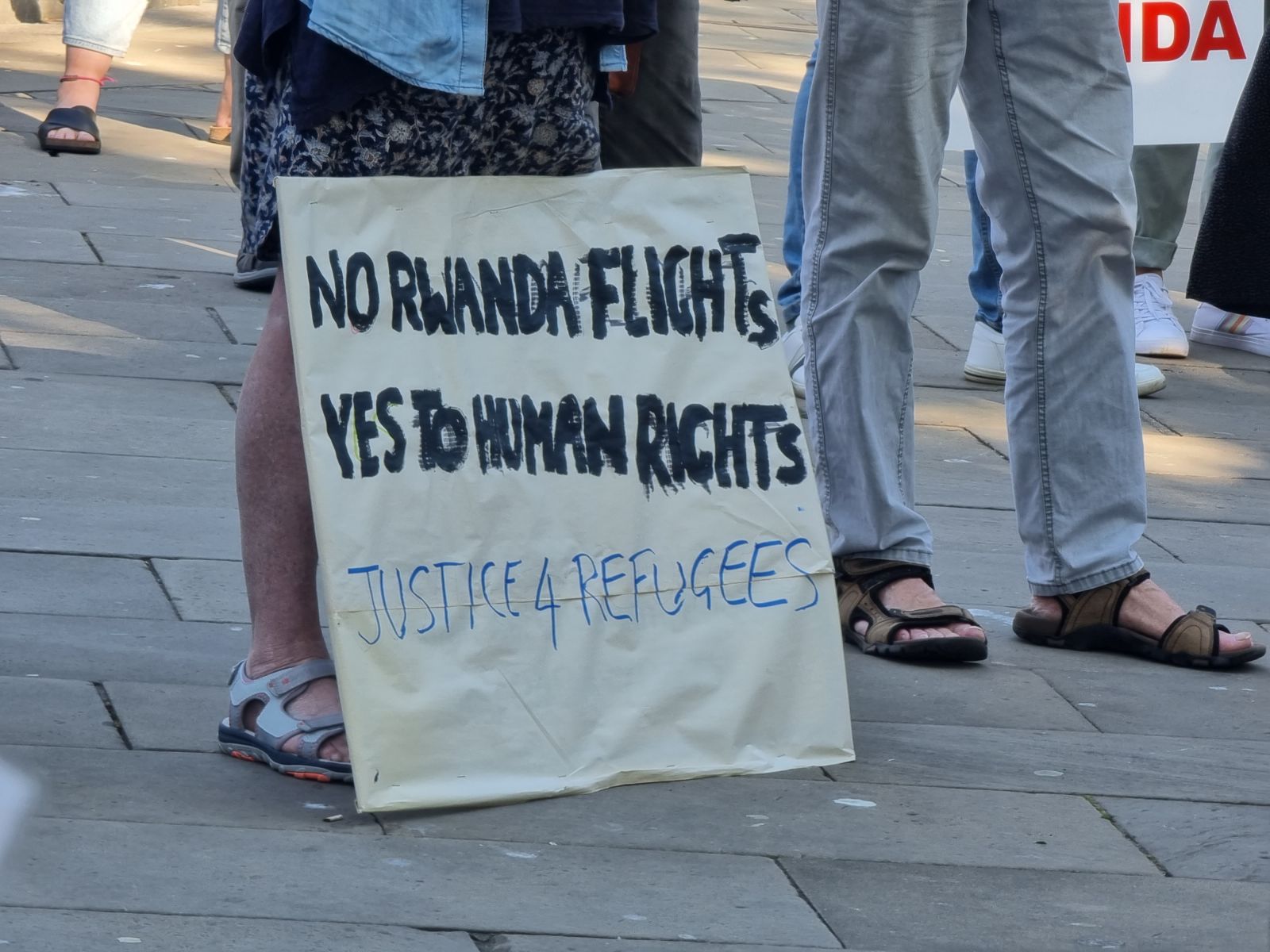 placard saying 'Justics4Refugees'