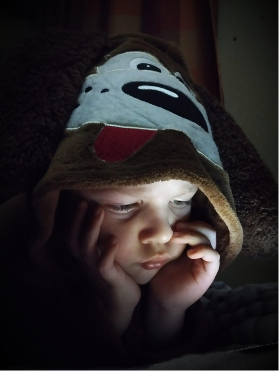 A young boy reading in the shelter