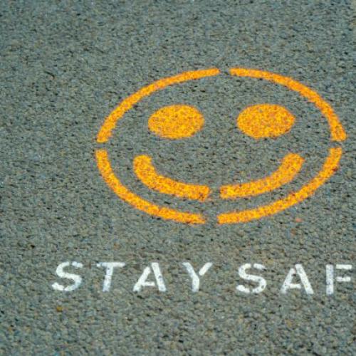 yellow smily face on the ground with text STAY SAFE