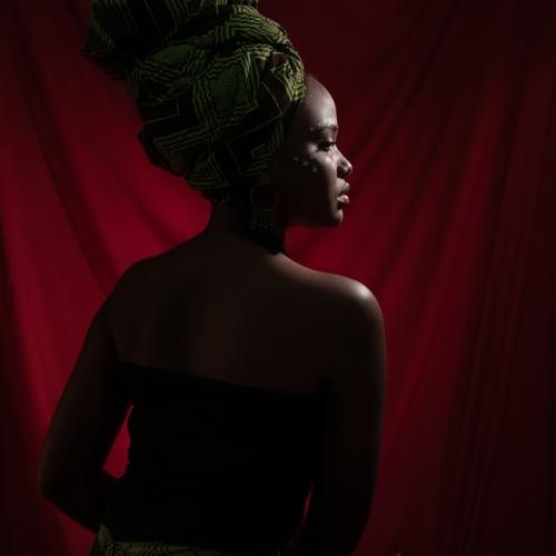 Fegor Lois Onoworemu posed in a red backdrop