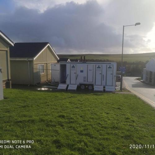 Penally camp is shown with a menacing grey cloud behind it