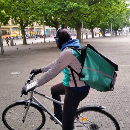 migrate student deliverooing on bike in Netherlands