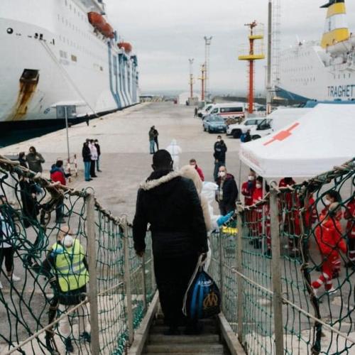 Refugee walks off boat