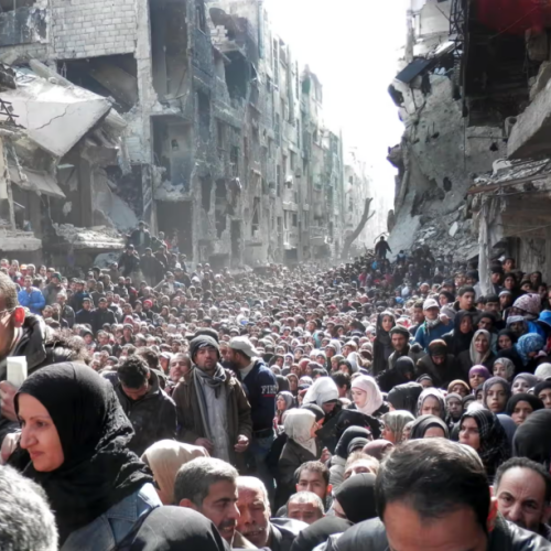 Palestinian refugees queuing for food in the Yarmouk refugee camp AP Photo/UNRWA