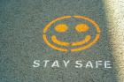 yellow smily face on the ground with text STAY SAFE