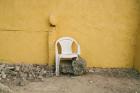 white chair in front of yellow wall