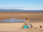 women sitting on Welsh beach