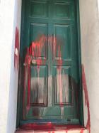 The vandalised doorway of a refugee support worker in Greece