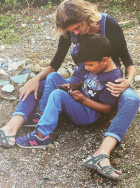 a women sits together with a boy