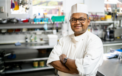 A smiling chef standing in a kitchen