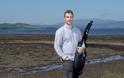 Grant, an Open University in Scotland social work graduate and professional bagpiper.  