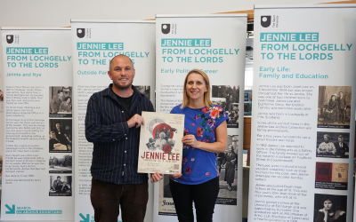 Matthew Knights from Knights Theatre and Louise Davison from the OU at the Jennie Lee exhibition and holding a poster for the Jennie Lee play. 