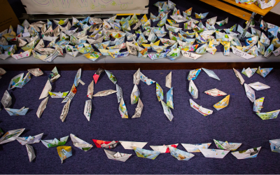 The word 'Change' spelled with paper boats. 