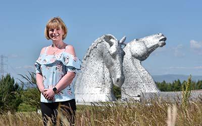 OU in Scotland graduate Emma, pictured in front of The Kelpies