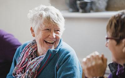 Two people in conversation, smiling