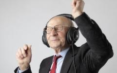 Photo of an older person dancing whilst wearing headphones 