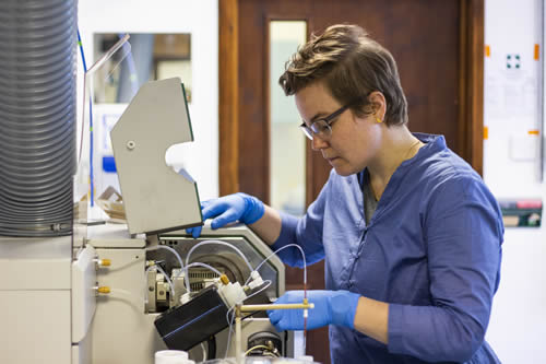 Woman using large, industrial polishing equipment