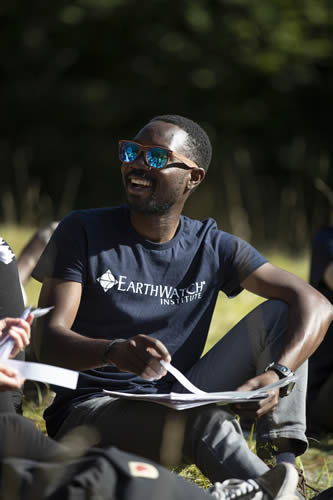 Male student sitting, working in a fields