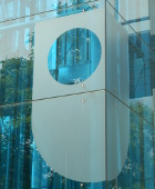 Glass side of a building showing the OU logo