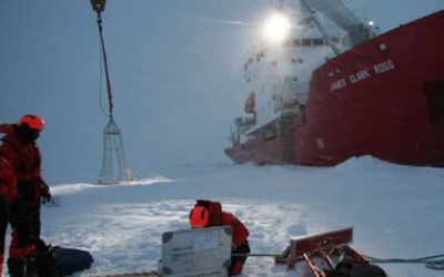 Professor Mark Brandon working on the ice in front of a ship