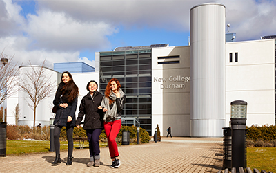 Image of New College Durham with students in the foreground
