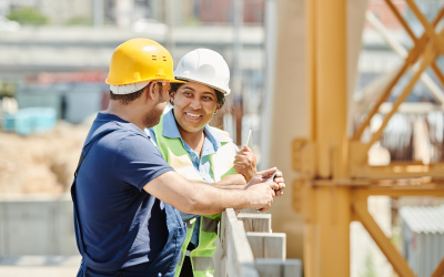 A male and a female having a conversation on a construction site. 
